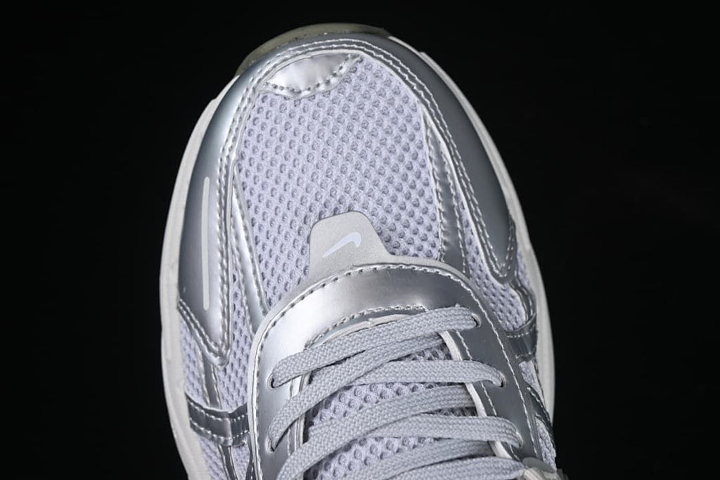 Top view of the silver-trimmed toe and mesh upper