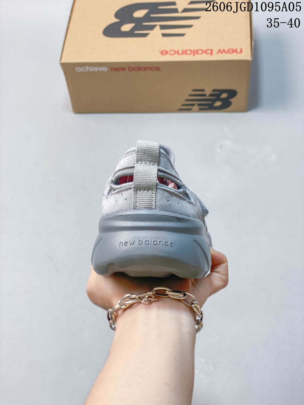 Rear view of the gray sneaker with heel pull tab and sculpted sole