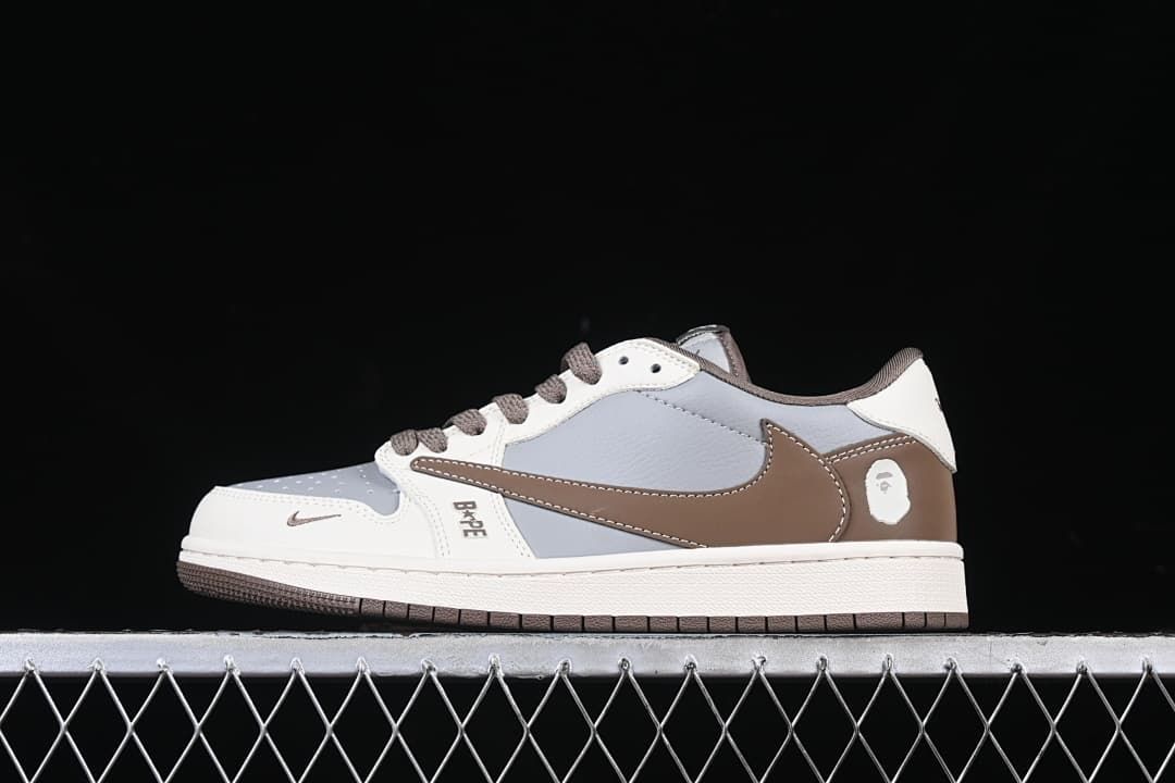 Side view of the low-top sneaker with white, gray, and brown panels and a brown Swoosh.