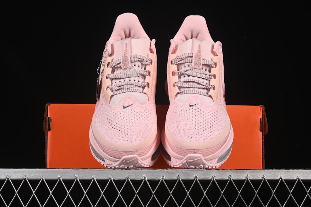 Front view of the pair of pink running shoes displayed on the box