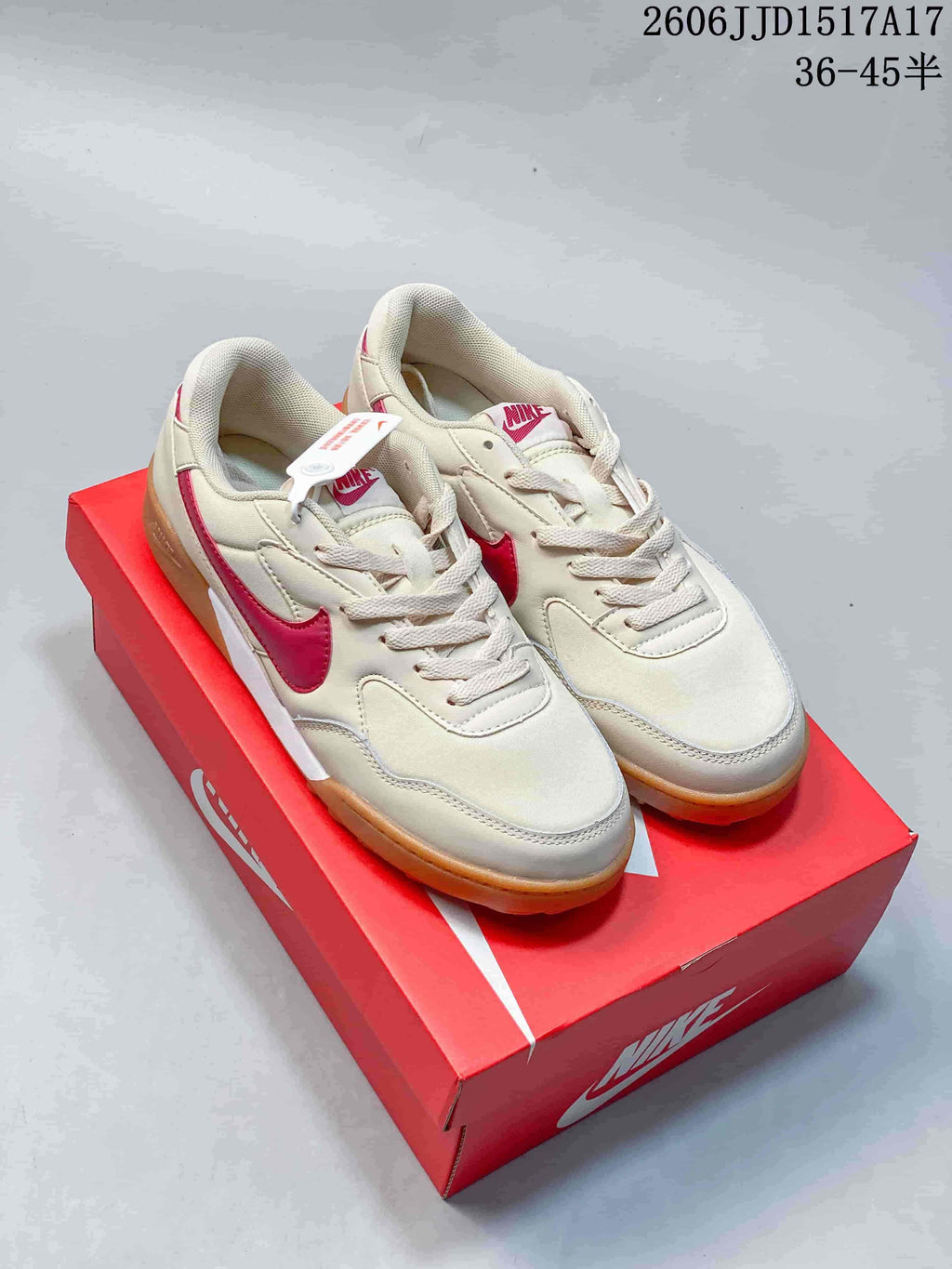 Pair of cream Nike Terra Manta sneakers with pink accents and gum-colored soles