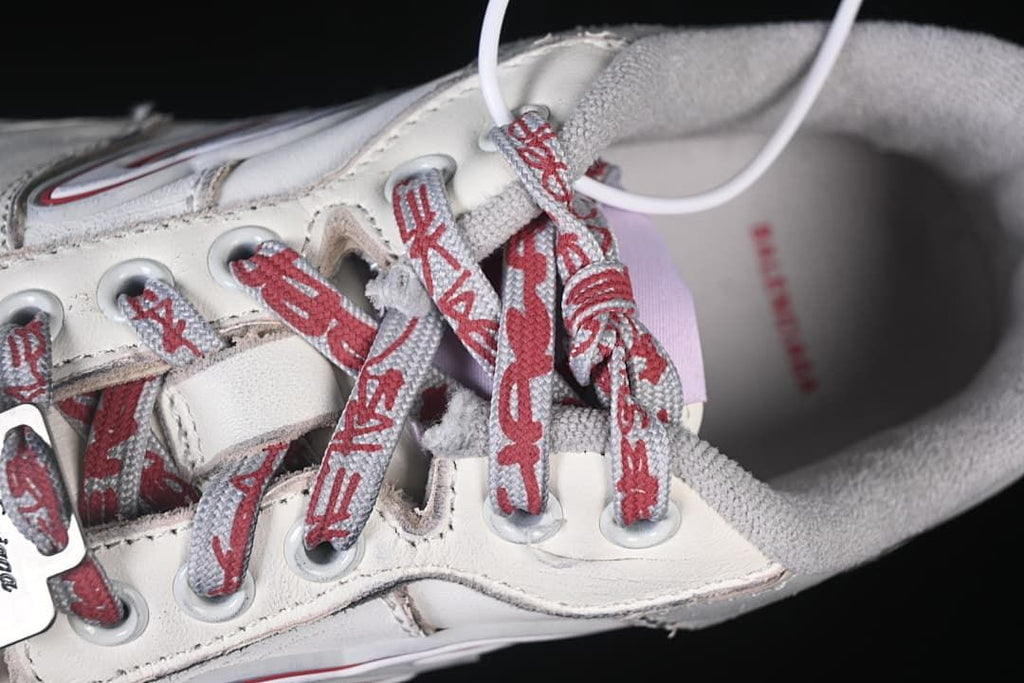 Close-up of patterned red and grey laces