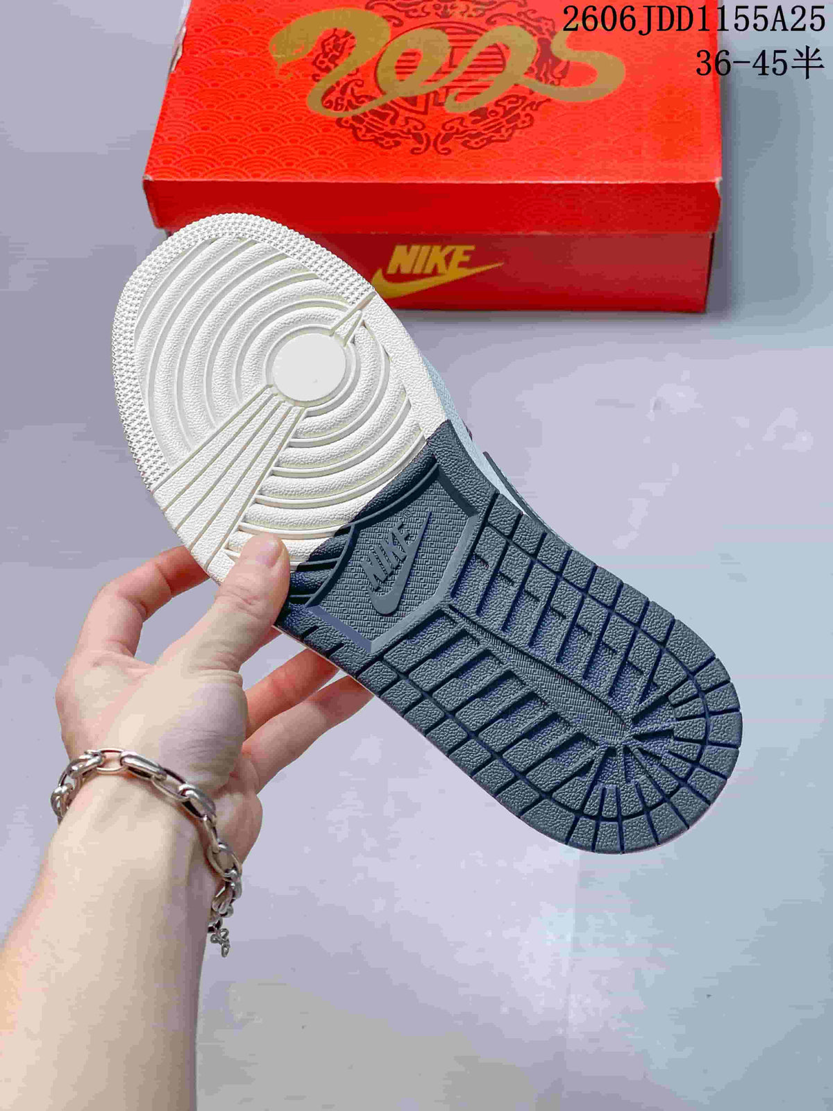 Underside of the sneaker showing a two-tone patterned outsole