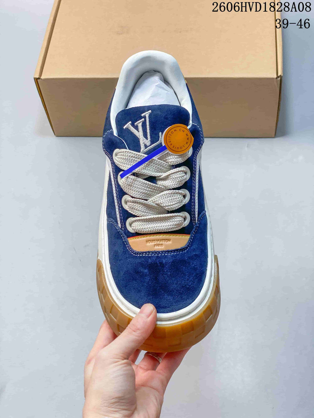 Top view of a blue lace-up sneaker with a prominent tongue logo