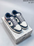 Pair of navy and cream low-top sneakers with patterned laces displayed on a patterned box