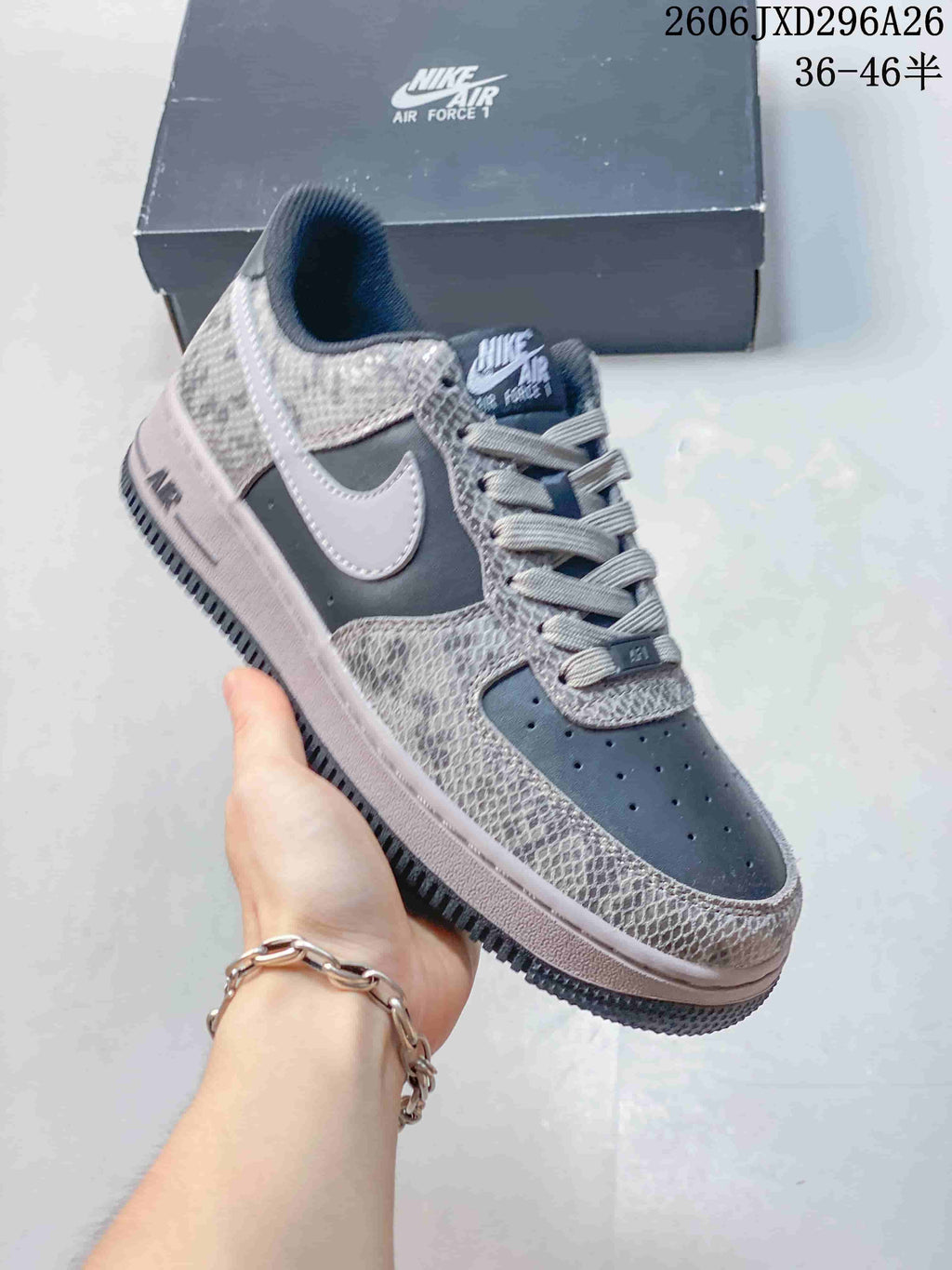 Close-up of a charcoal Nike Air Force 1 sneaker with a pale Swoosh