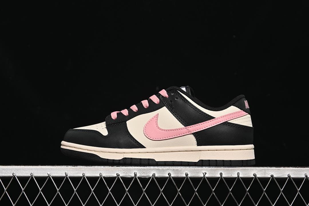 Side view of a black, off-white, and pink Nike Dunk Low sneaker