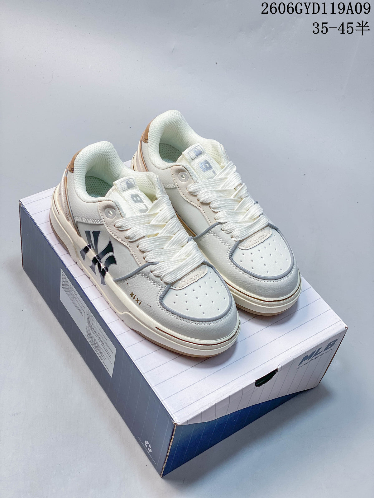 Pair of white MLB Chunky Liner low-top sneakers with graphic side details, shown on a shoebox