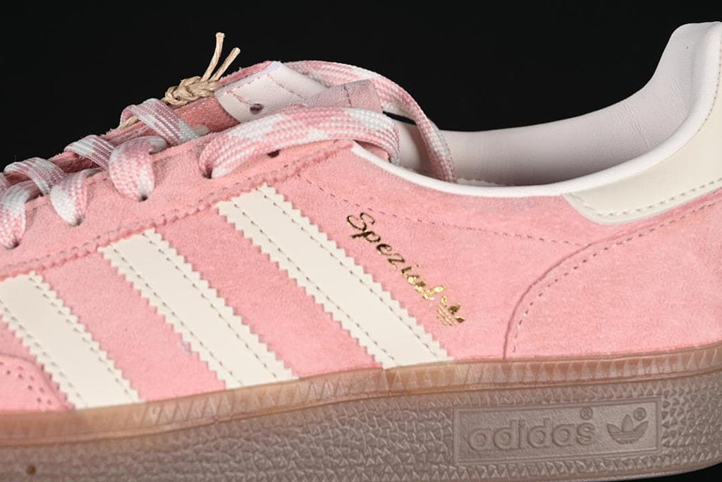Close-up of the pink upper, off-white stripes, laces, and Spezial lettering