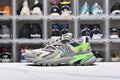 Side view of a gray and lime green chunky low-top sneaker