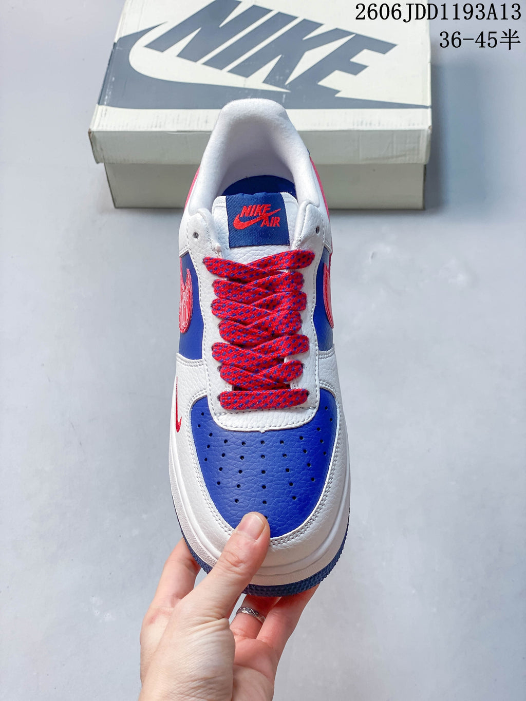 Top view showing the blue toe panel and red-and-blue patterned laces