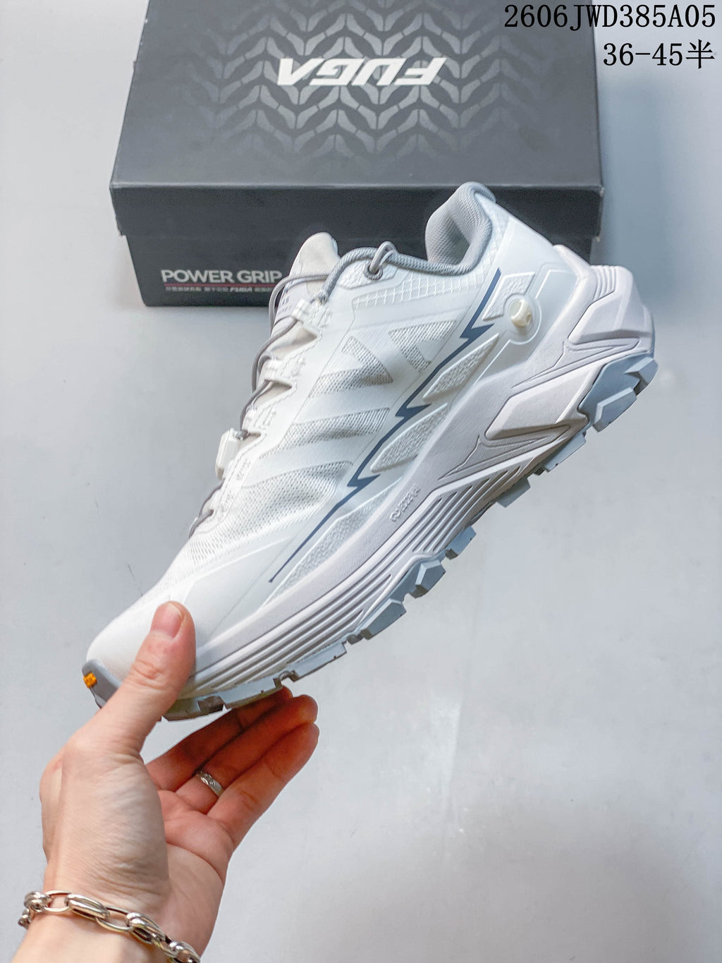 Side view of the white and gray Kailas Fuga Ex3 trail shoe