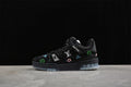 Black Louis Vuitton low-top sneaker with colorful motifs, shown in profile