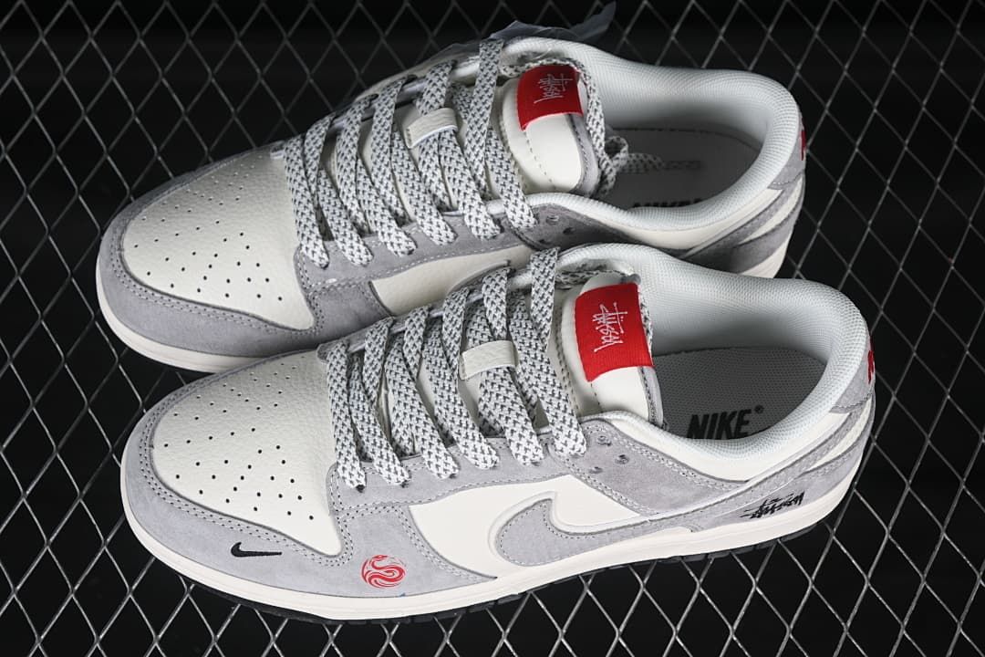 Top view of a pair of gray and off-white low-top sneakers with patterned laces