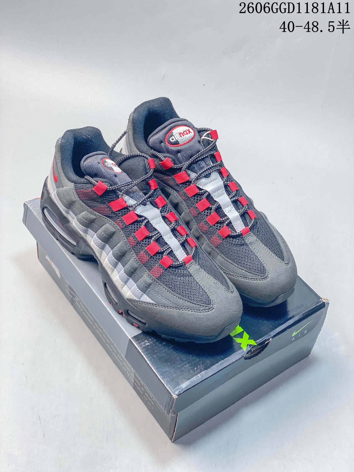 Pair of grey and red Nike Air Max 95 OG sneakers on a shoebox
