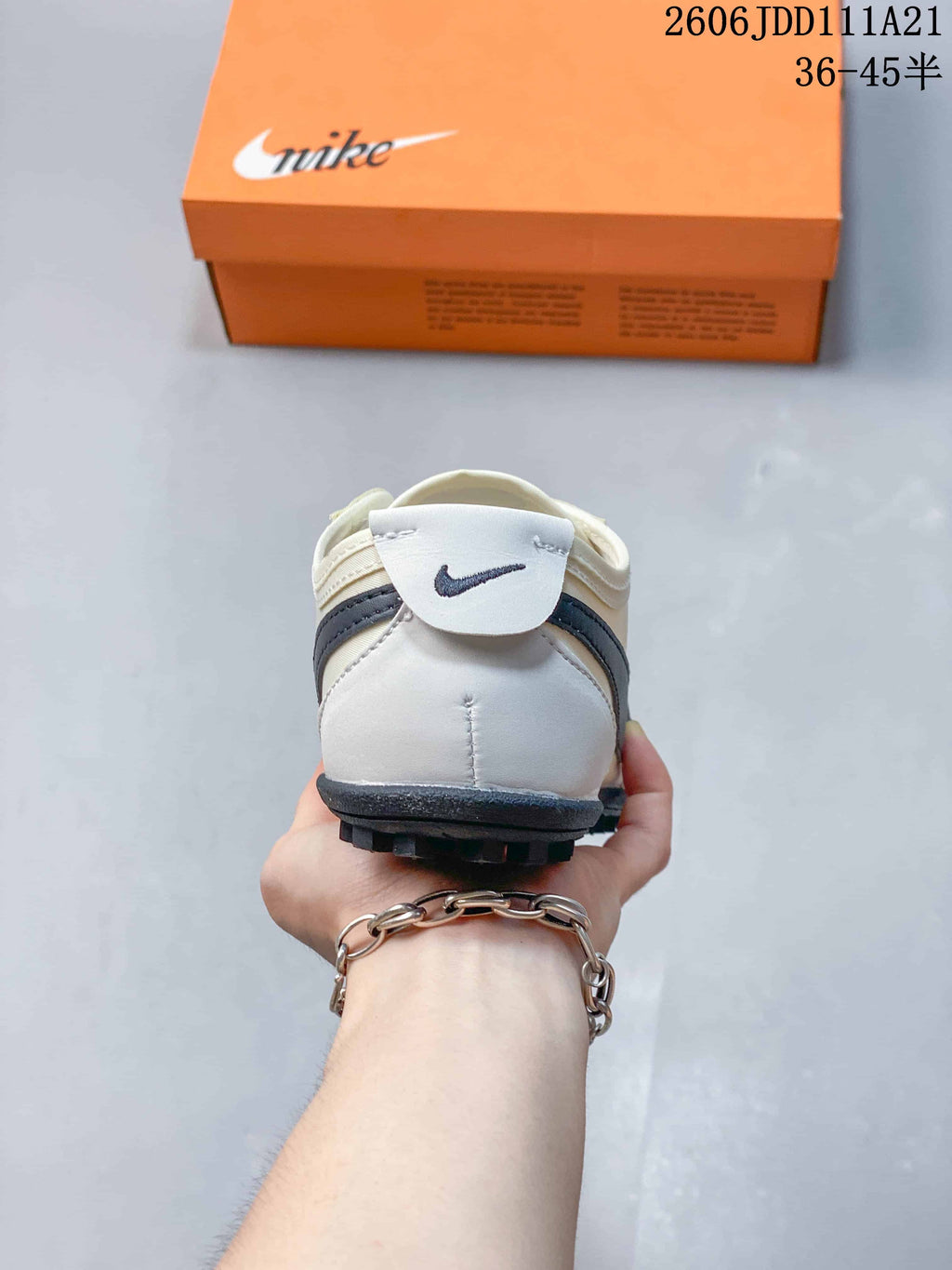 Rear view of an off-white Nike Moon Shoe OG Summit sneaker with dark heel detailing