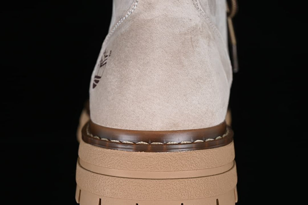 Rear view showing the boot's heel, stitched welt, and layered tan sole