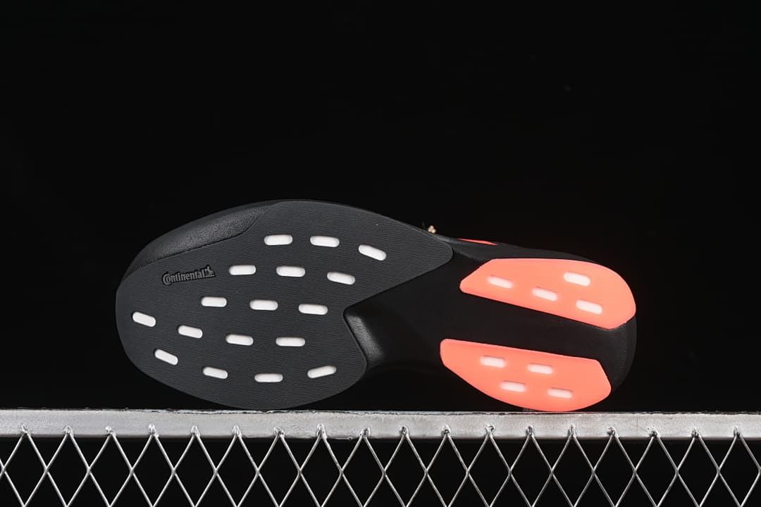 Outsole view with contrasting coral sections and visible Continental marking