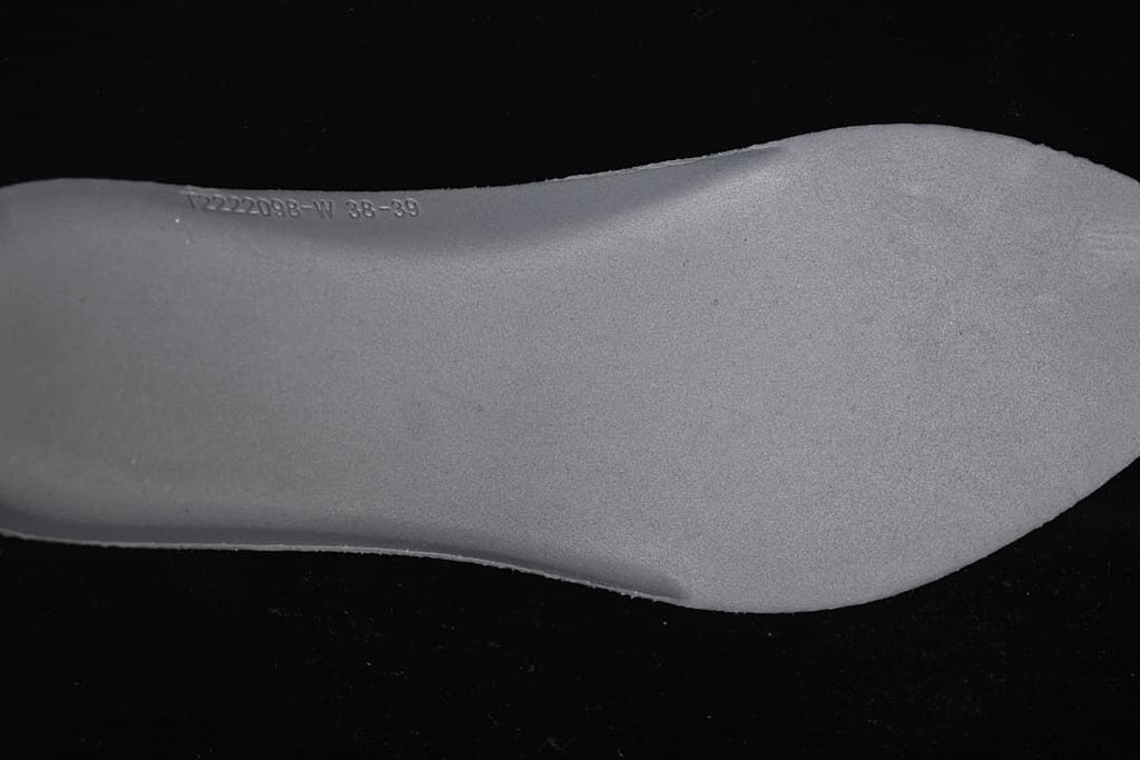 Close-up of a shoe insert with a size range marking.