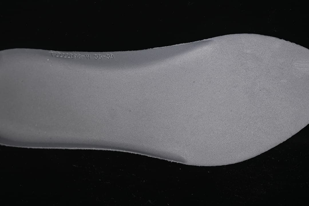 Close-up of a shoe insert with a size range marking.