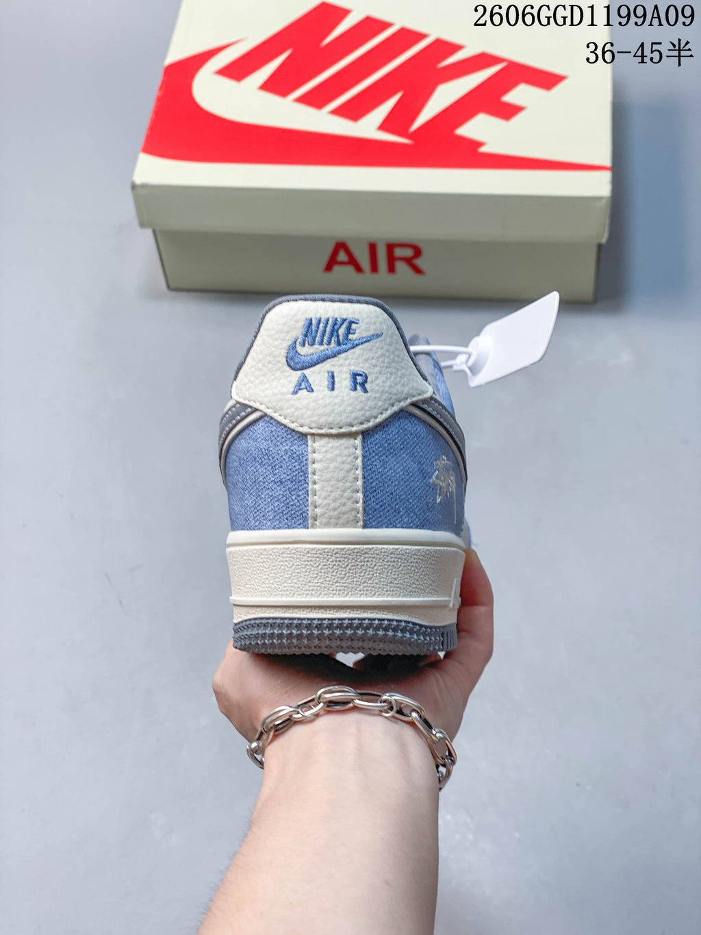 Rear view showing the blue heel panel and off-white heel tab.