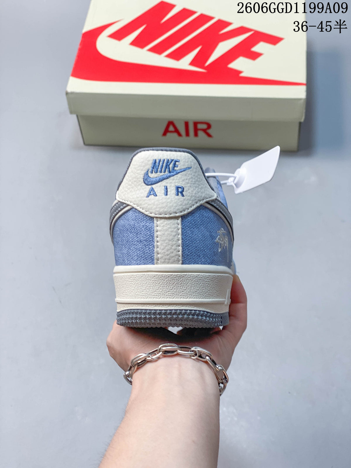 Rear view showing the blue heel panel and off-white heel tab.