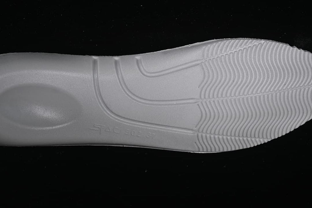Close-up of the sneaker's white outsole and tread.