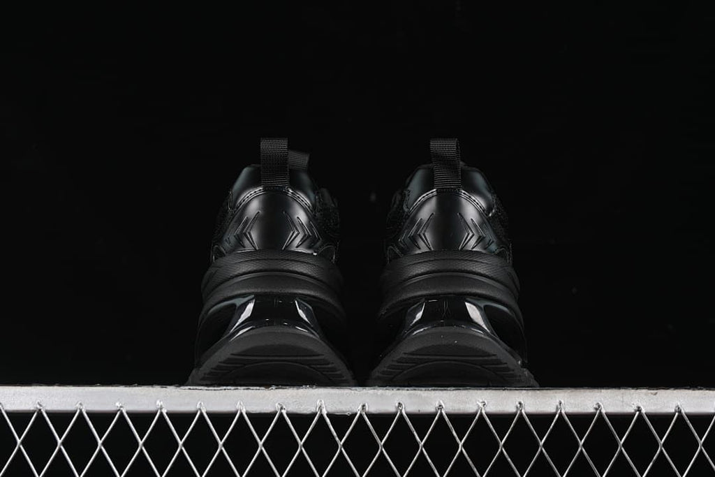 Rear view of the pair showing heel details and sculpted soles.