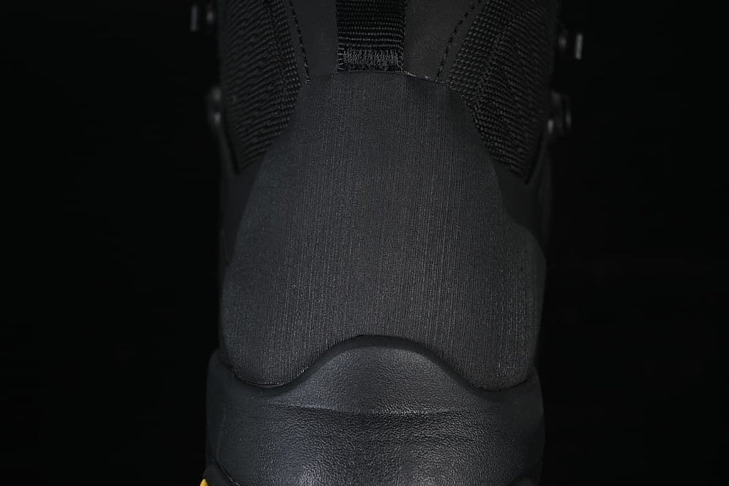 Rear close-up of the black boot's heel and collar.