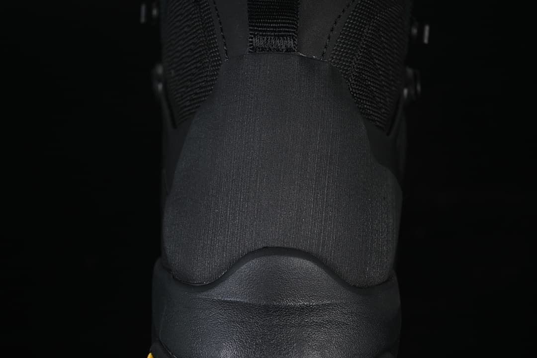 Rear close-up of the black boot's heel and collar.