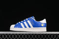 Blue and white Superstar low-top sneaker shown from the side