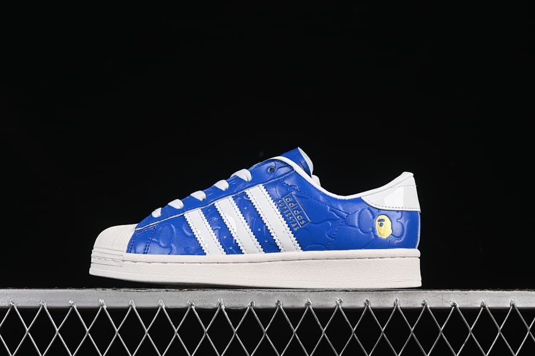 Blue and white Superstar low-top sneaker shown from the side
