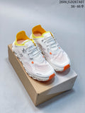 Pair of white On Cloud 6 Coast sneakers with yellow collars and orange accents, shown on a shoe box