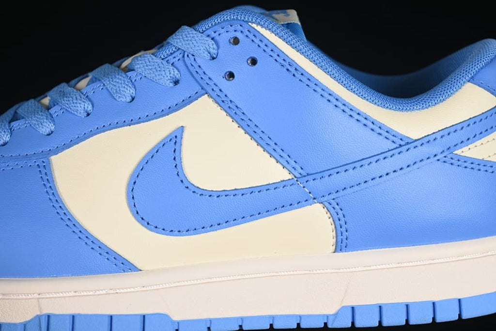 Close-up of the blue side panels, cream panel, Swoosh, and midsole