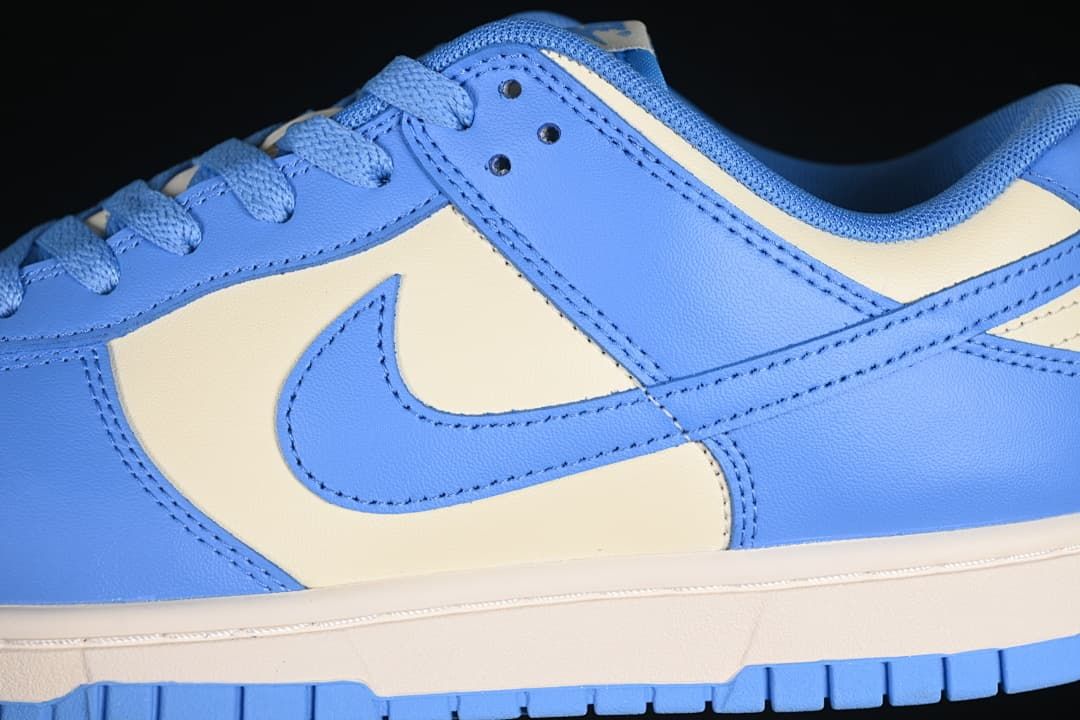Close-up of the blue side panels, cream panel, Swoosh, and midsole