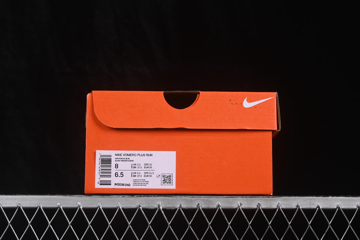 Orange shoe box with a visible label identifying Nike Vomero Plus Run and style code IM2038-040.