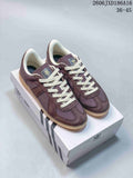 Pair of purple-brown adidas BW Army low-top sneakers with cream laces on a shoebox