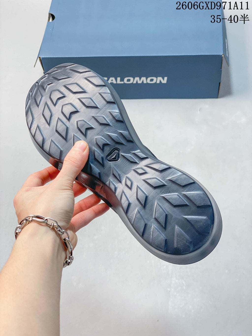Close-up of the patterned outsole on a gray Salomon sneaker