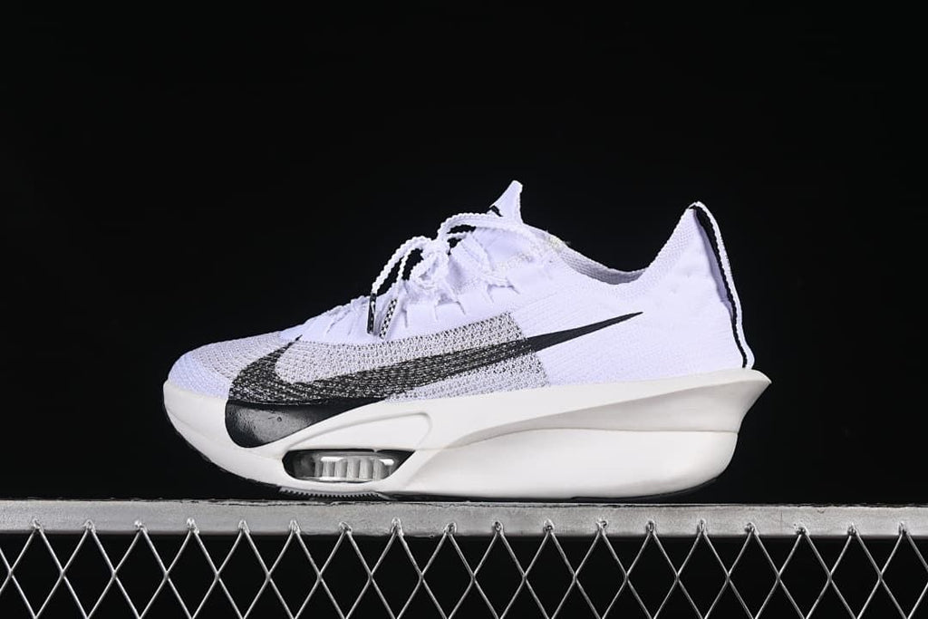 Side view of a white Nike running shoe with a large black Swoosh and sculpted sole