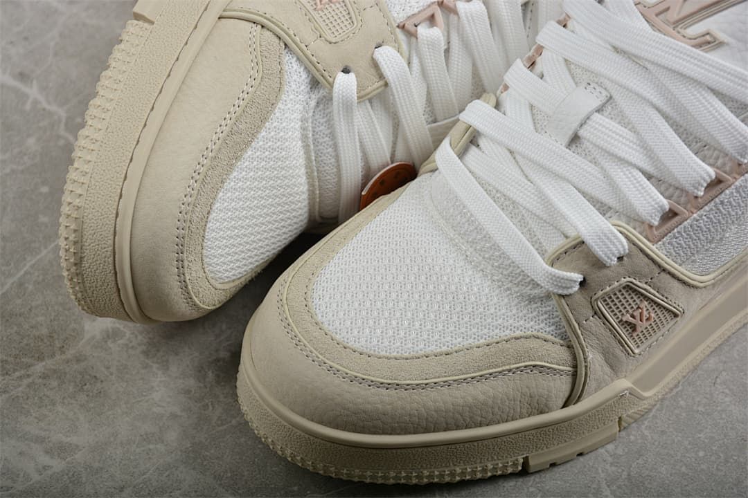 Close-up of the white mesh panels, beige overlays, and laces.