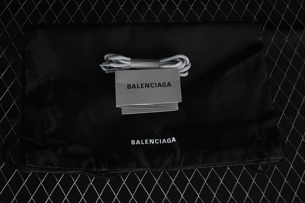 Black branded drawstring bag and an additional pair of grey laces