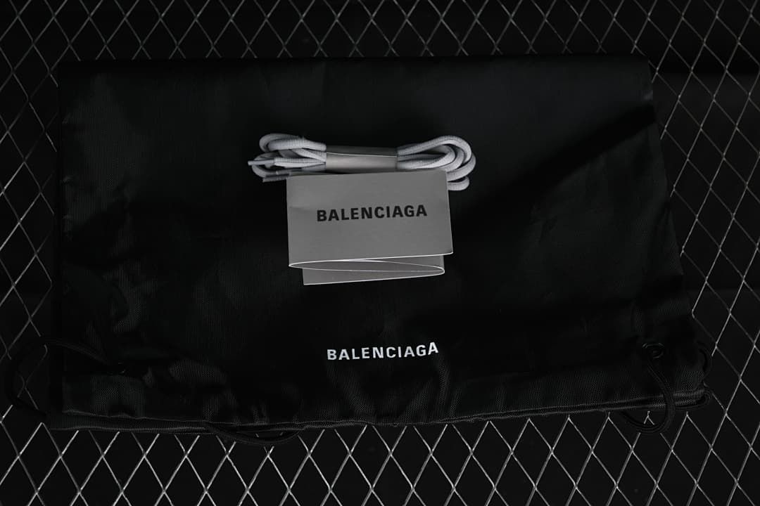 Black branded drawstring bag and an additional pair of grey laces