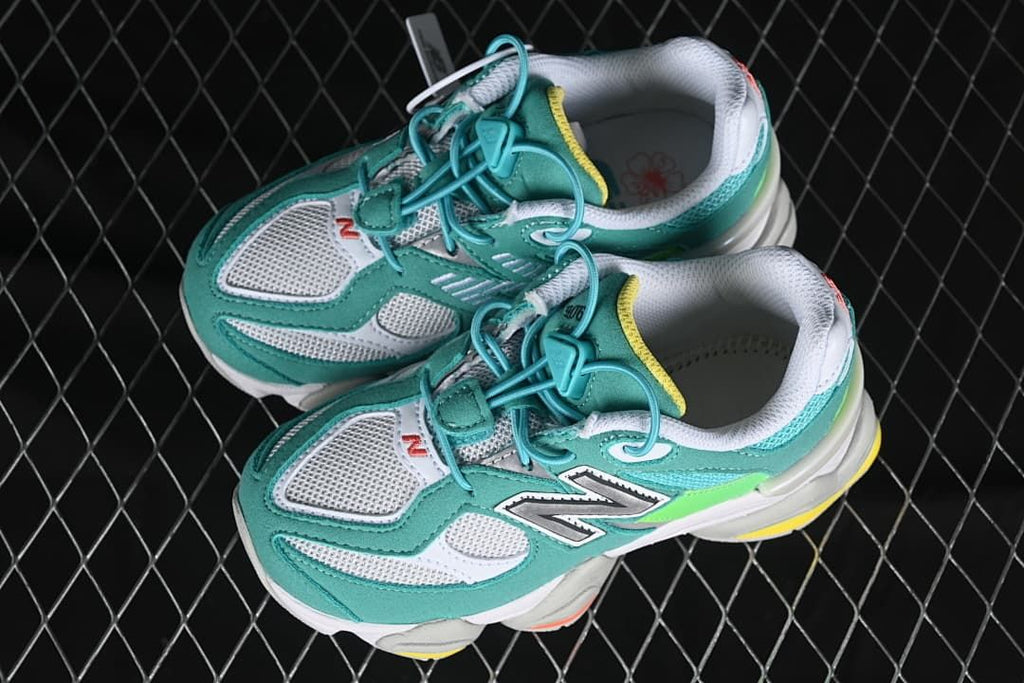 Pair of teal and white kids sneakers shown from above