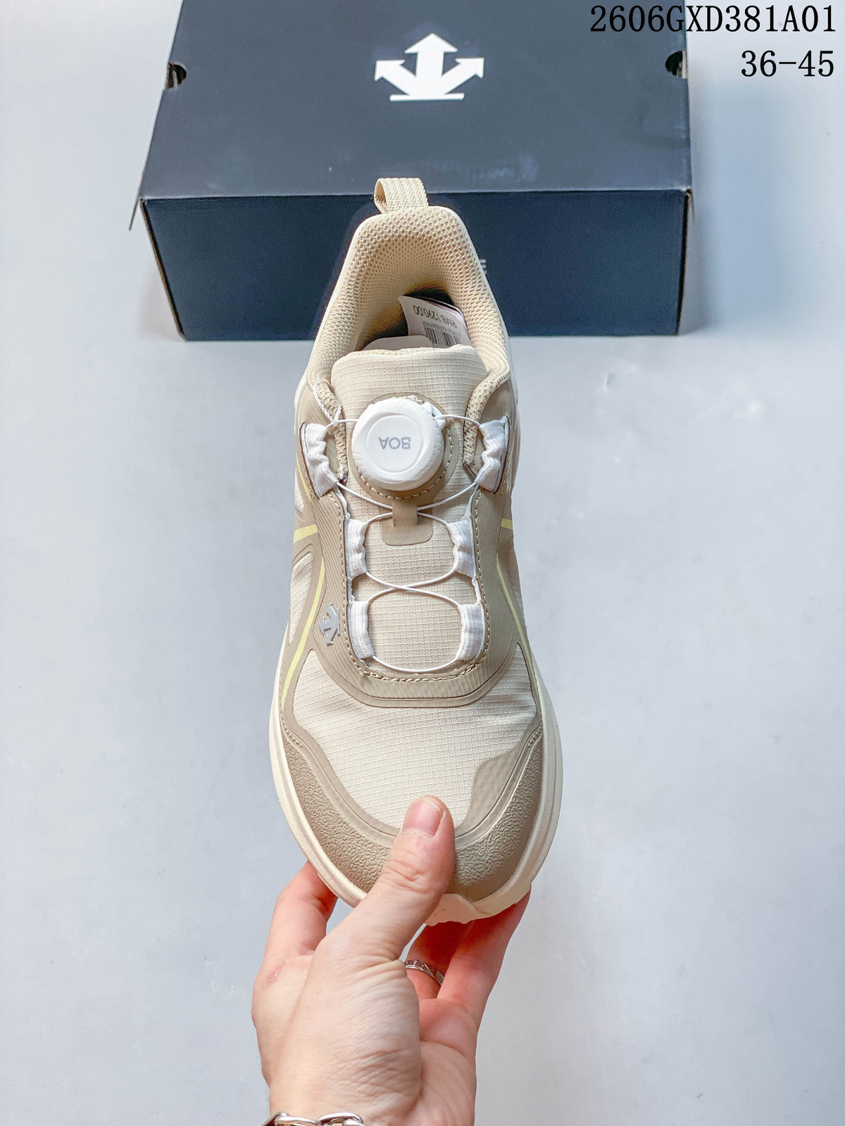 Top view of the beige DESCENTE sneaker showing its dial and cable-style closure