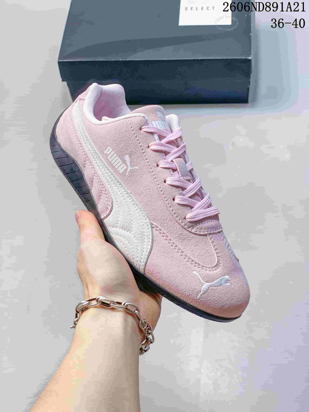 Angled side view of a pink Puma Speedcat OG sneaker