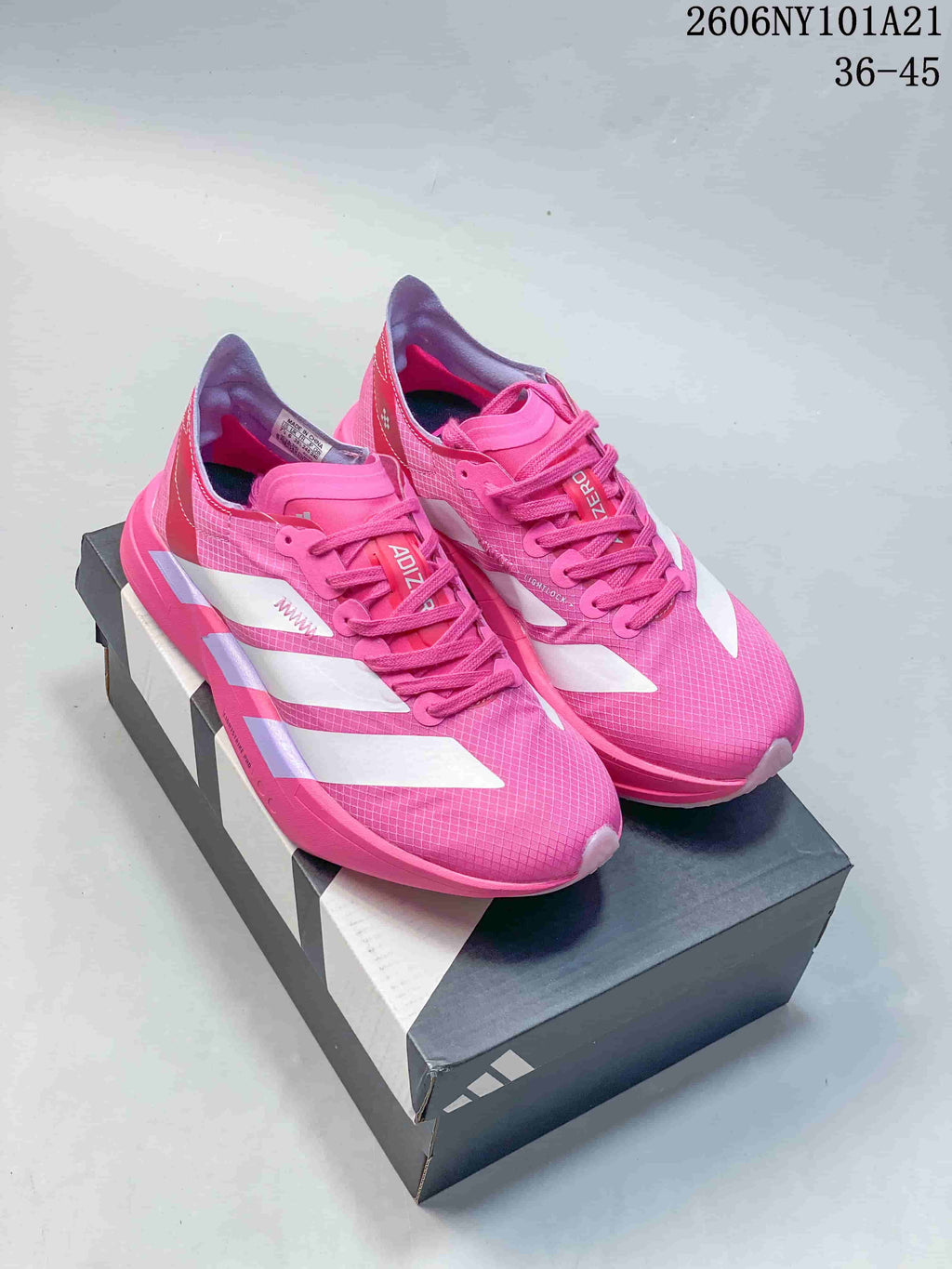 Pair of pink and white adidas Ultrabounce shoes on a shoebox
