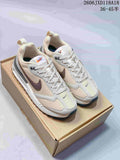 Pair of light neutral Nike Air Max Dawn sneakers on a box, shown from above