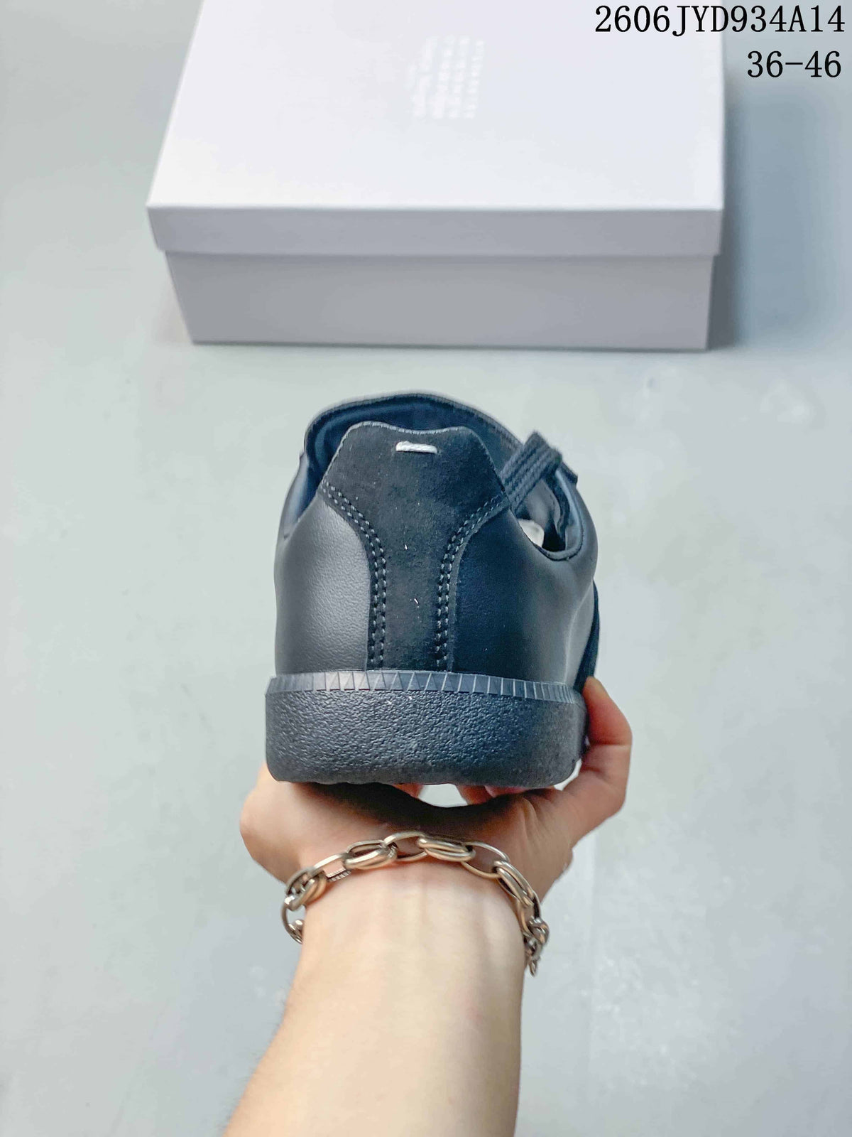 Rear view showing the heel and layered panels of a dark navy sneaker