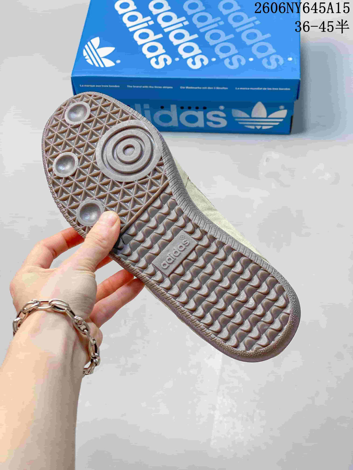 Close-up of the patterned gum-colored outsole of a taupe sneaker.