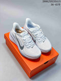 Pair of white and grey Nike Pegasus 42 running shoes on an orange shoebox